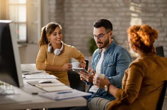 Team in a business meeting around a tablet